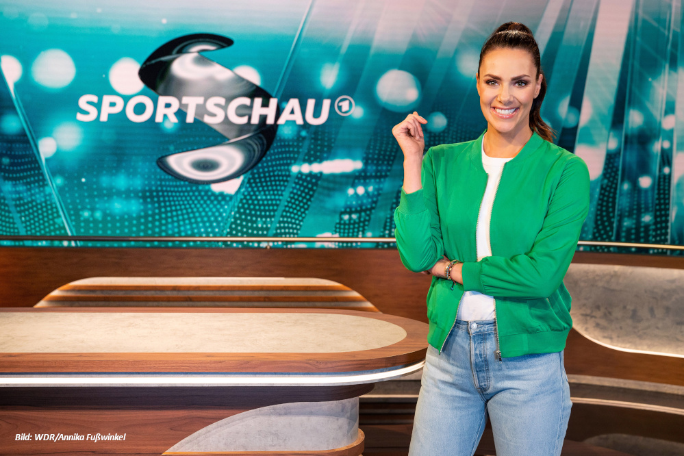 Esther Sedlaczek steht im Sportschau Studio vor dem Logo der Sendung