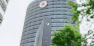 Vodafone Gebäude mit Router im Vordergrund